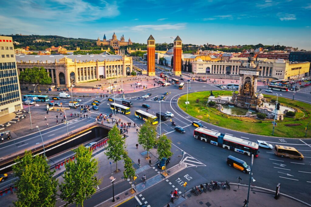 Placa d'Espanya, Barcelona, Spain with city traffic on sunset